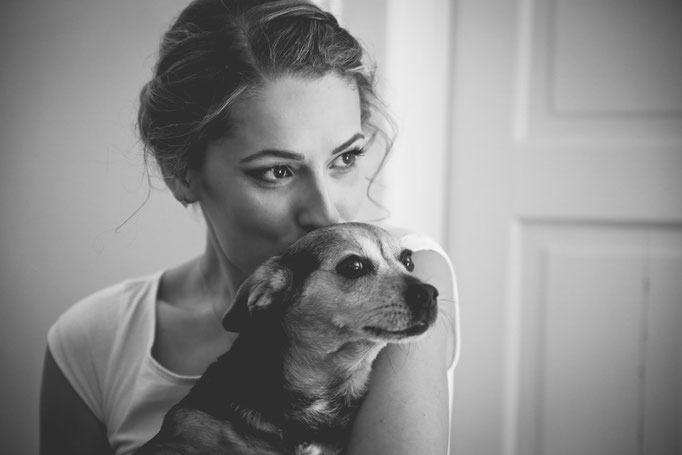 Braut hält ihren Hund im Arm